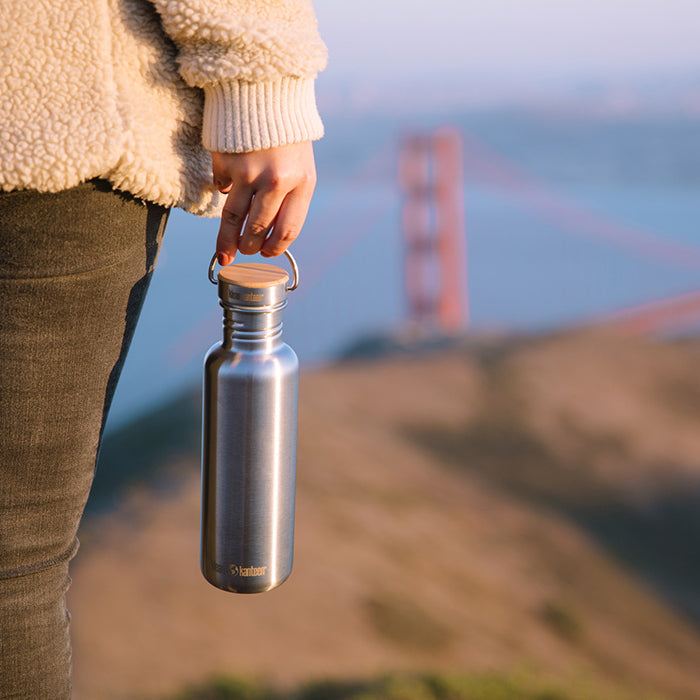 27oz-reflect-with-bamboo-cap-b3 K27SSLRF-BS-BAMBOO_reflect_bottle_bridge_lifestyle.jpg