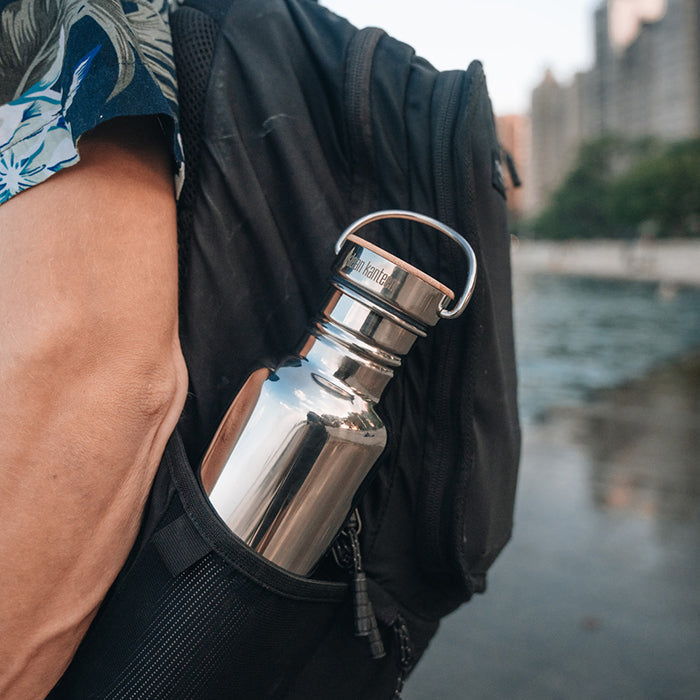 27oz-reflect-with-bamboo-cap-b3 K27SSLRF-MS-BAMBOO_reflect-bottle_backpack_lifestyle.jpg